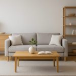 A minimalistic living room with a gray sofa, wooden coffee table, and a plant vase on the table.